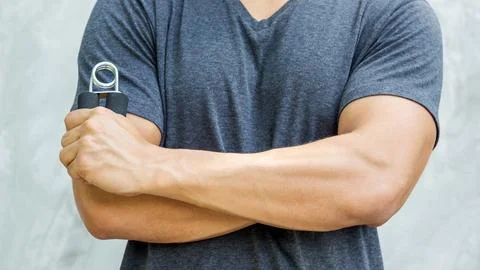 Man use handgrips for exercise. Stock Photos