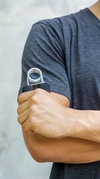 Man use handgrips for exercise. Stock Photos