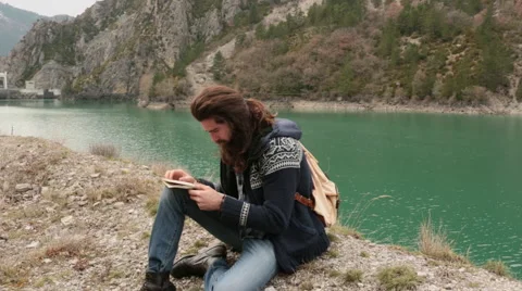 Man use a map near river 動画素材 64575934
