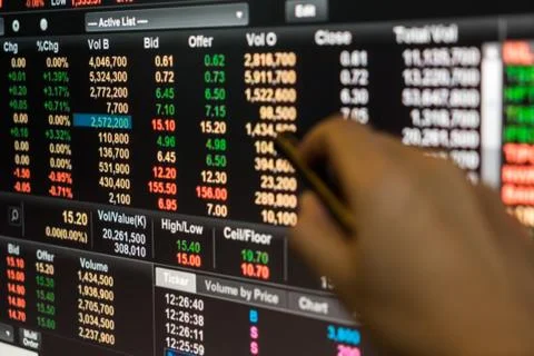 Man use pen point to Data graph of stock market financial chart Stock Photos