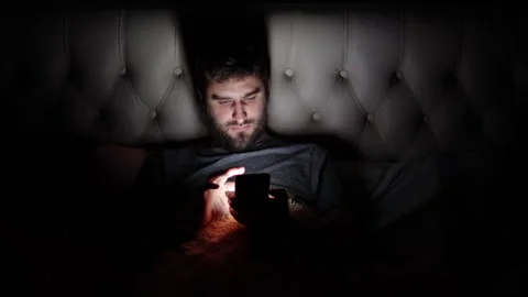 Man use smartphone in the dark before going to bed in bed Stock Footage 143090660