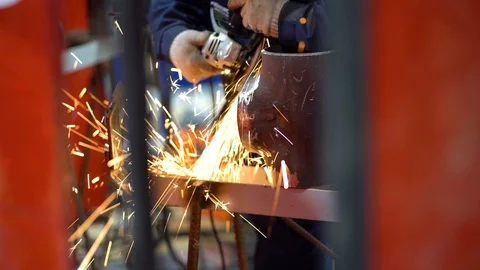 Man use special sander, grinds, aligns and smoothest sharp edge of metal pipe  Stock Footage 126357451