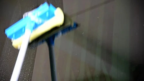 The man use squeegee to cleaning the glass of building Stock-Footage 297597034