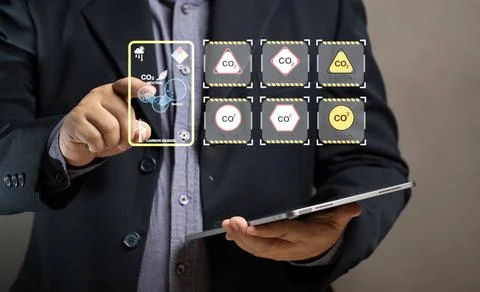 Man use tablet to show the virtual co2 diagram. Air pollution values. Data .. Stock Photos