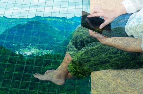 Man use Tablet while Relaxing beside Water Pool with Scenic of City in Mounta Stock Photos