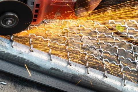 Man used angle grinder without cover guard cutting metal net to make bird cag 스톡 사진