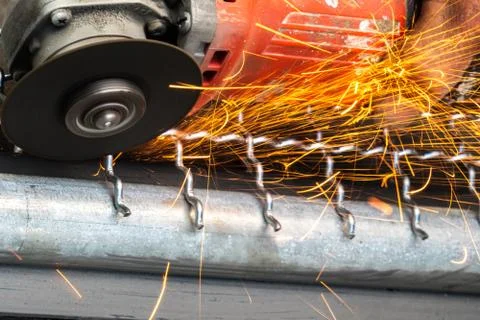 Man used angle grinder without cover guard cutting metal net to make bird cag Stock Photos