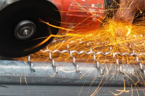 Man used angle grinder without cover guard cutting metal net to make bird cag Stock Photos