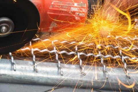 Man used angle grinder without cover guard cutting metal net to make bird cag Stock Photos