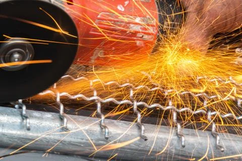 Man used angle grinder without cover guard cutting metal net to make bird cag Stock Photos