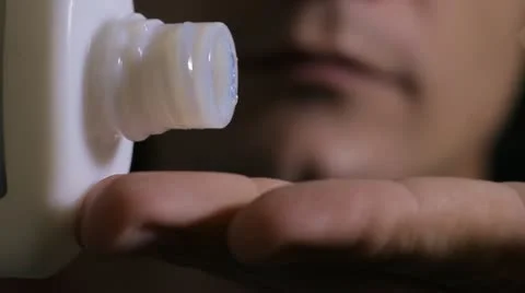 Man uses aftershave cream Stock Footage 12003404