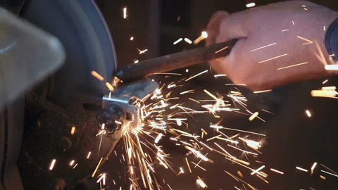 Man uses angle grinder in workshop in slow motion Stock Footage 87769477