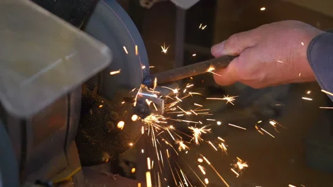 Man uses angle grinder in workshop in slow motion 180fps Stock Footage 109179349