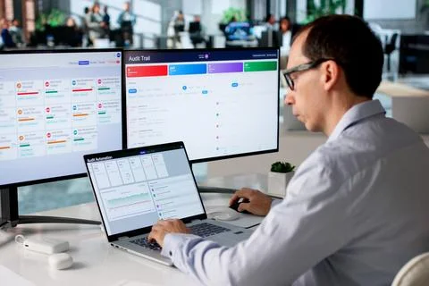 Man Uses Automated Software System To Monitor Financial Risk Continuously. Stock Photos