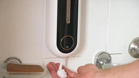 Man uses Automatic Foaming Wall Mounted Motion Sensor Touchless Liquid Soap Stock Footage 244789671