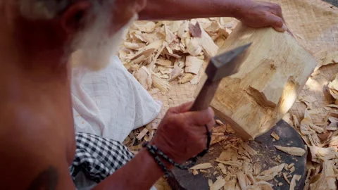 A man uses an axe to carve a mask Stock Footage 290904682