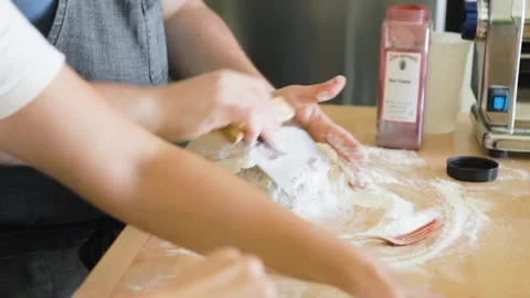 Man uses bench scraper to knead flour into pasta dough Stock Footage 199152443