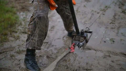 Man uses big track jack in slow motion. Try to get stucked car from mud and dirt Stock Footage 77430336