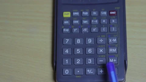 The man uses a calculator that lies on the table. Video stock 169810246