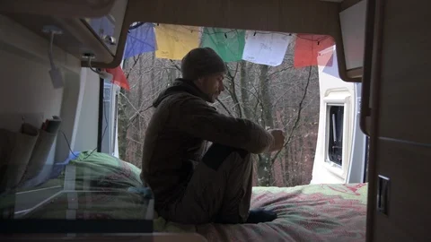 Man uses the cell phone from the camper. Immersed in nature Stock Footage 98042736