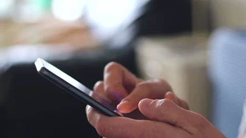 A man uses a cell phone to record and send a close-up message. Hold a mobile Stock Footage 236955248
