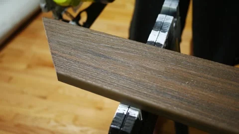 Man uses Circular Saw to Cut Composite Deck Board 2 Stock Footage 344826210