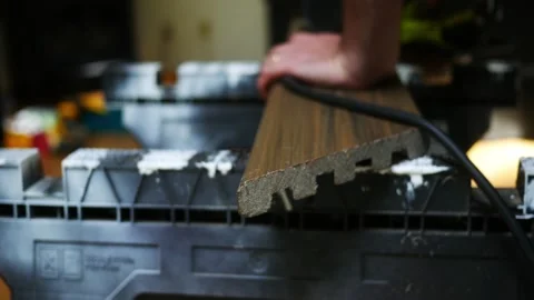 Man uses Circular Saw to Cut Composite Deck Board Stock Footage 344826394