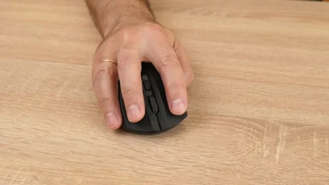 A man uses a computer mouse, clicking buttons and using the scroll wheel Stock Footage 318588948