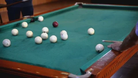 Man uses a cue to hit the ball Stock Footage 81543681
