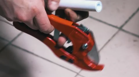 Man Uses a Cutting Tool for Cut of Polypropylene Pipes Stock Footage 68955835