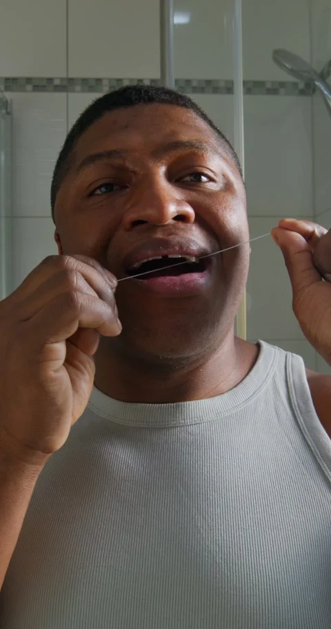 A man uses dental floss Stock Footage 313085737