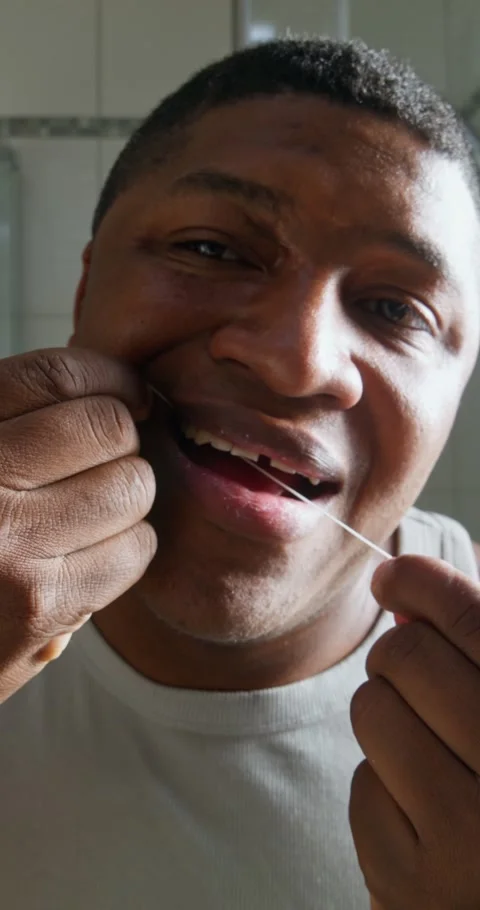 A man uses dental floss Stock Footage 313085765