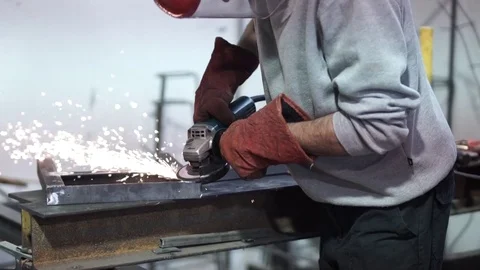 Man uses disc tool to grind metal in his workshop Stock Footage 81859365