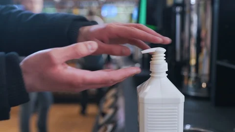 A man uses a dispenser with a sanitizer Stock Footage 127790550