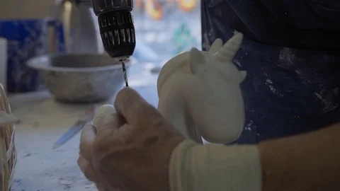 A man uses a drill when creating figures Stock Footage 102258540