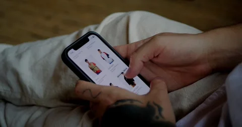 Man uses an e-commerce website to buy outerwear Stock Footage 282962789