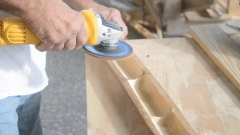 Man uses electrical hand held buffer to polish wood work B 動画素材 125057241