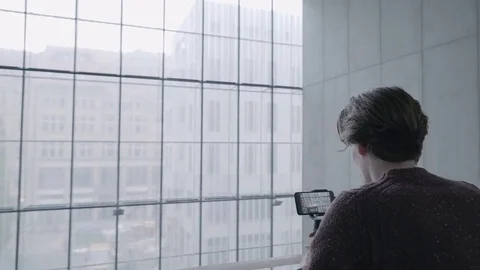 A man uses a gimbal stabilizer to shoot on a mobile device The technology of the 스톡 동영상 80775439