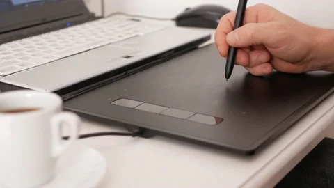 Man uses graphics tablet, laptop. Pencil pen, designer photographer retouches Stock Footage 165046073