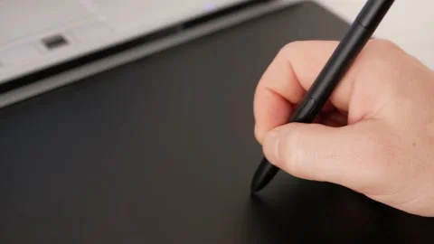 Man uses graphics tablet, laptop. Pencil pen, designer photographer retouches Stock Footage 165046335