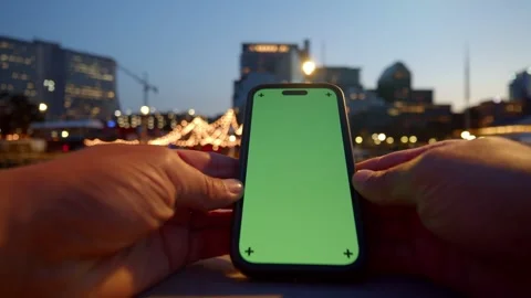 Man Uses Green Screen Smartphone In City At Night - Urban Technology Stock Footage 309476520