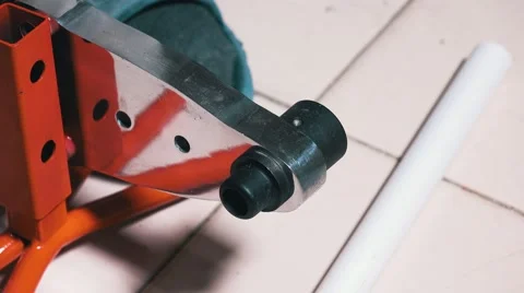 Man Uses a Heating Machine for Welding of Polypropylene Pipes Stock Footage 68955936