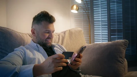A man uses his smartphone to securely make an online purchase Video stock 283967961