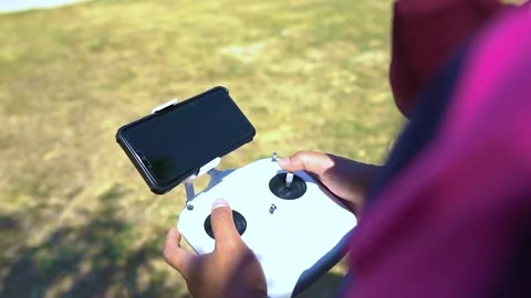Man uses a joystick to control a drone. Stock Footage 156010854