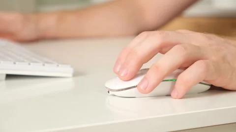 The man uses a keyboard and mouse. young man typing on computer keyboard Stock Footage 242298622