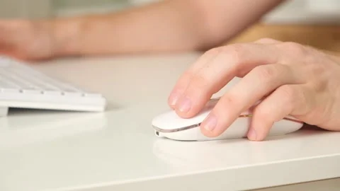 The man uses a keyboard and mouse. young man typing on computer keyboard Stock Footage 242298654