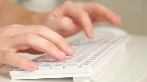The man uses a keyboard and mouse. young man typing on computer keyboard Stock Footage 242298685