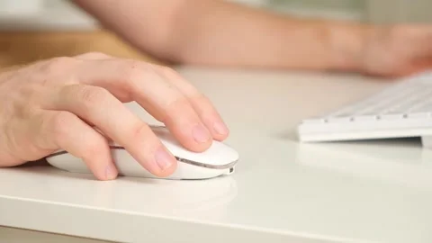 The man uses a keyboard and mouse. young man typing on computer keyboard Stock Footage 242444352