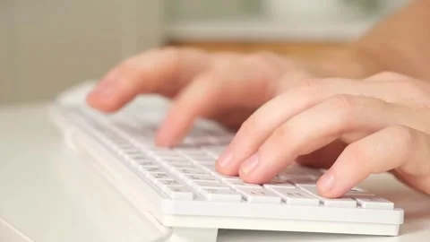 The man uses a keyboard and mouse. young man typing on computer keyboard Stock Footage 242444417