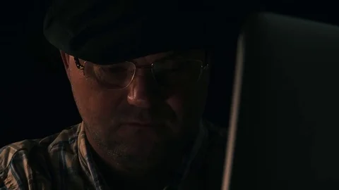 Man uses a laptop computer in his home office Video stock 78490839